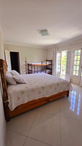 a bedroom with a large bed in a room at Casa Clorophila, suíte master completa com banheira, para 3 hóspedes in Vila Velha