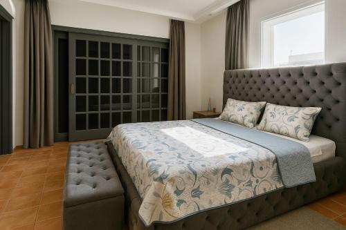 a bedroom with a large bed and a large window at Spacious villa in Founty, beach side 40m front Sofitel in Agadir
