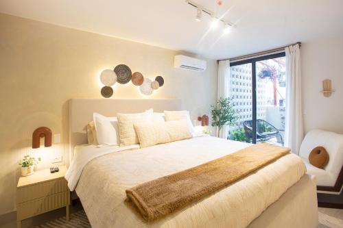 a bedroom with a large bed and a window at CASCO 114, king bed Stylish and Cozy apartment near Casco in Panama City