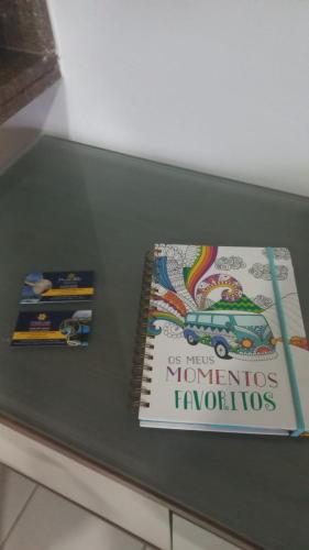 two books sitting on top of a table at Estúdio Marulhos, varanda com vista de mar e parque aquático, à beira-mar de Muro Alto, wi-fi, restaurante, estacionamento e a 10' de Porto de Galinhas in Porto De Galinhas