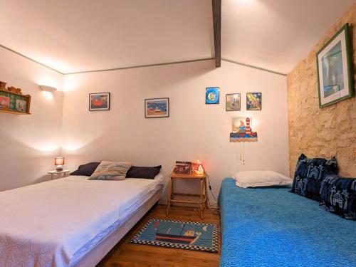 a bedroom with two beds and a blue carpet at Moulin Authentique avec Jardin Privé et Activités pour Familles et Amis en Bord de Rivière - FR-1-653-251 in Saint-Mary
