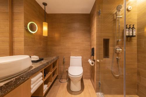 a bathroom with a toilet and a shower at Hyatt Regency Kuantan Resort in Kuantan