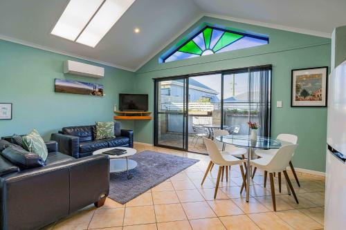 a living room with a couch and a table at Albany Harbourside Apartments And Houses in Albany