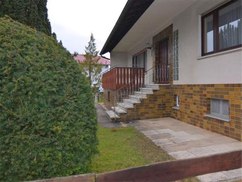 a house with a large bush in front of it at Exclusives Ferienhaus in Frankenau im Sauerland in Frankenau