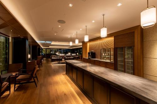a bar in a restaurant with tables and chairs at The Hotel Seiryu Kyoto Kiyomizu - a member of the Leading Hotels of the World- in Kyoto