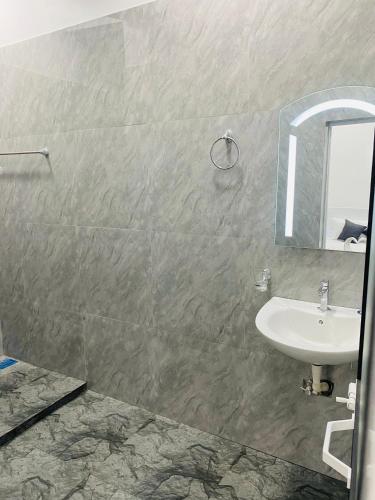 a bathroom with a sink and a mirror at Hotel Jay R in Trincomalee