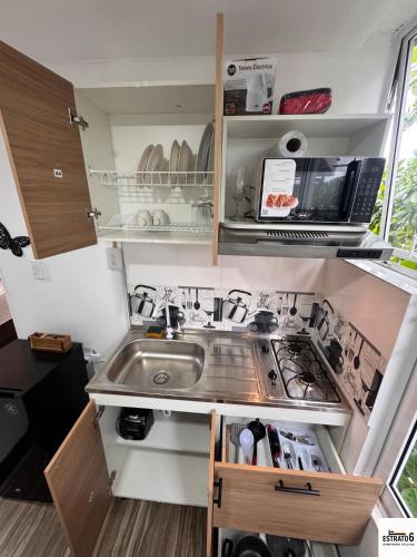 a small kitchen with a sink and a stove at Estrato6 Apart Studios in Villanueva