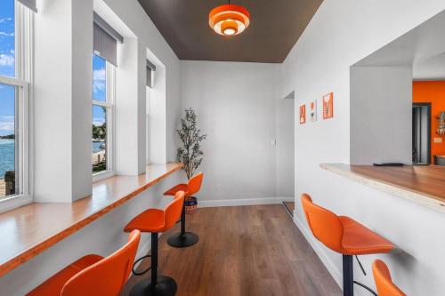 a waiting room with orange chairs and a counter at On The Dock by Westlynn in Little Current