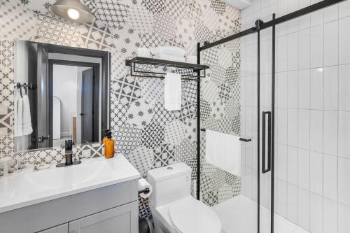 a bathroom with a shower and a toilet and a sink at On The Dock by Westlynn in Little Current