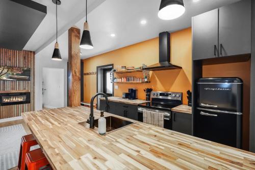 a kitchen with a wooden counter top in a room at On The Dock by Westlynn in Little Current