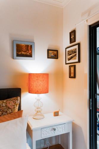 a bedroom with a bed and a table with a lamp at Oceanside Escape, Heated Pool, Fire Pit and 4 Beds in New Brighton