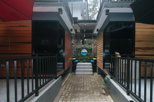 a hallway of a building with a stairway with a building at RedDoorz @ Dolce Cabanas Beach Resort in Zambales