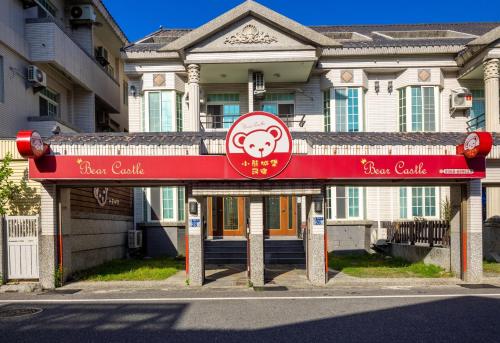a building with a red sign in front of it at 小熊城堡民宿-免費停車 !!新歌KTV-過山車電動麻將-露天烤肉-以上設備僅限包棟使用 # 選Villa才是包棟 # - 16人以下可少人包棟請電聯!! in Hualien City