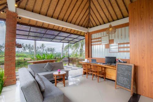 a living room with a couch and a table at Tanta Escape in Tegalalang
