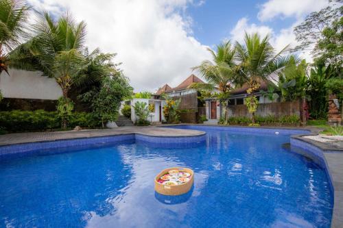 a swimming pool with a toy in the middle at Tanta Escape in Tegalalang
