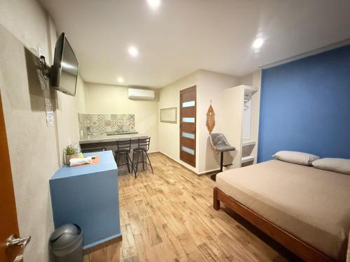 a bedroom with a bed and a desk with a sink at Hotel Casa-Noria Acapulco in Acapulco