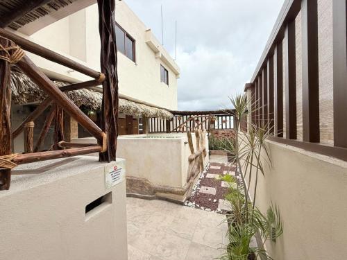 a balcony of a house with a fence and plants at Hotel Casa-Noria Acapulco in Acapulco