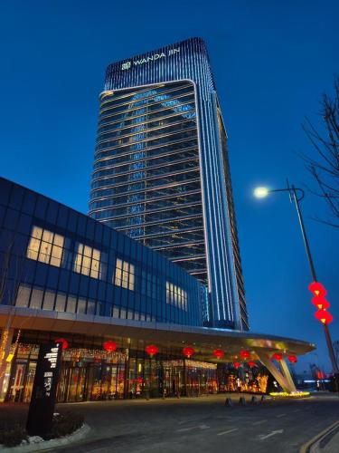 a tall building with a lot of windows at Wanda Jin Xiaohe Xincheng in Taiyuan