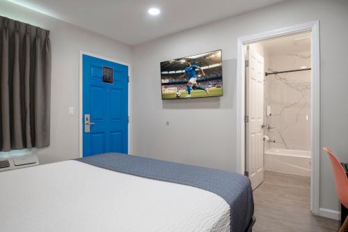 a bedroom with a bed and a tv on the wall at La Casita Inn in Wilmington