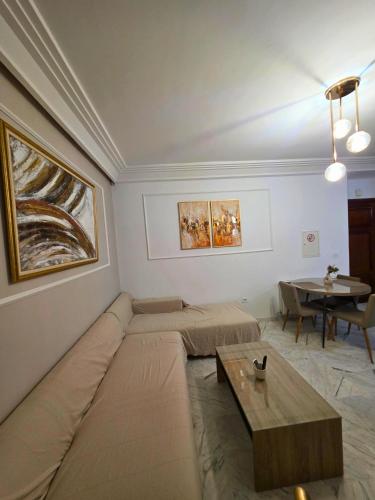 a living room with a couch and a table at Zen home Lac 2 in La Marsa