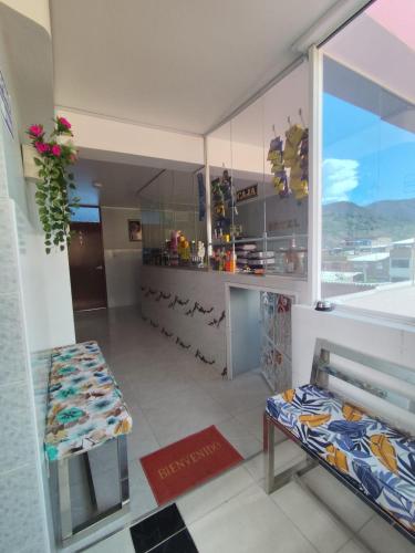 a shop with a window and a bench in a room at Hotel El Sol de Carhuaz in Carhuaz
