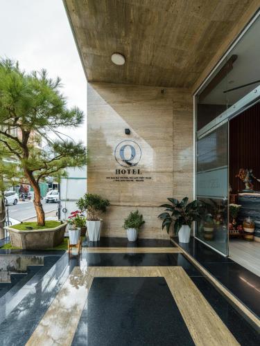 a lobby of a hotel with a sign on the wall at Celine Express - Q Dalat Hotel in Da Lat