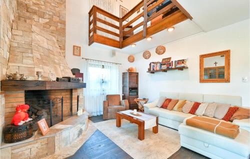 a living room with a couch and a fireplace at 3 Bedroom Cozy Home In Karlovac in Karlovac