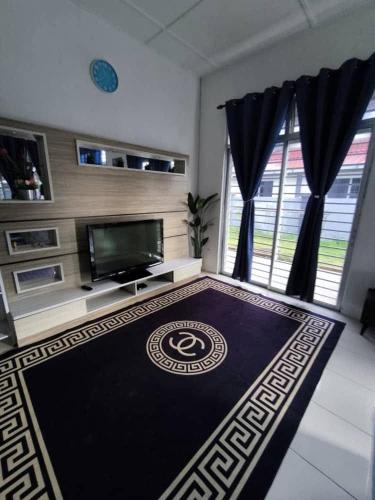 a living room with a black and white rug at Ahmad Albab Homestay in Pekan
