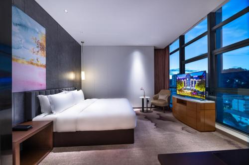 Postel nebo postele na pokoji v ubytování Mercure Shenzhen Longgang