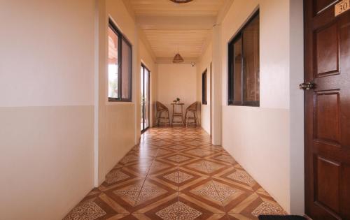 an empty hallway with a floor in a house at En Gedi Beach Resort by RedDoorz in Iba