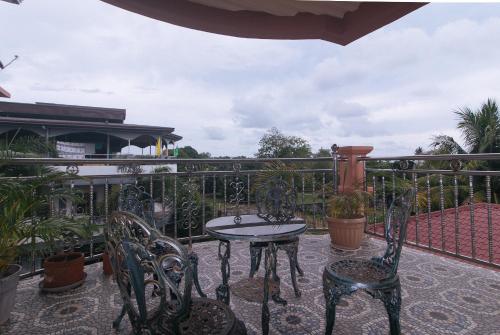 a patio with a table and chairs on a balcony at En Gedi Beach Resort by RedDoorz in Iba