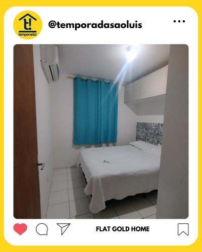 a room with a bed and a blue curtain at Flat Gold Home in São Luís