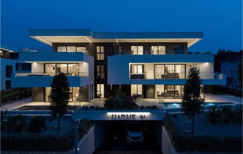 a large blue building with a night view at Lovely Apartment In Malinska in Malinska