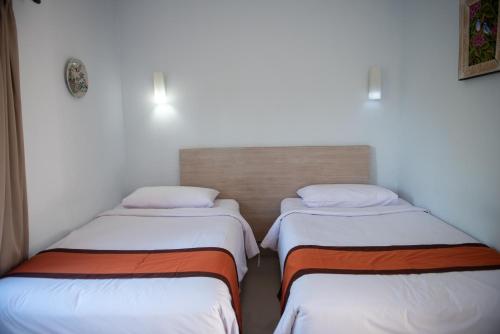 Postel nebo postele na pokoji v ubytování Abian Biu Mansion