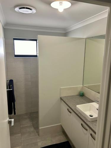 a bathroom with a sink and a mirror at Myalup Retreat in Binningup
