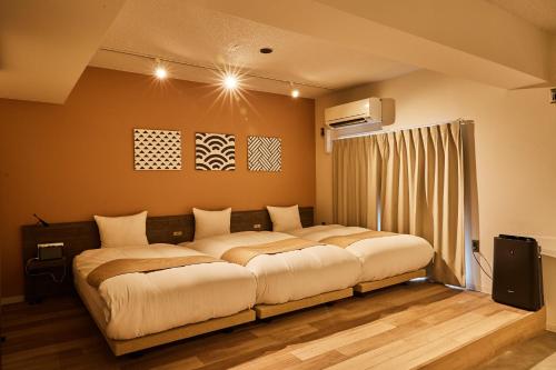 a bedroom with a large bed in a room at Riverside Arashiyama in Kyoto