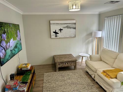 a living room with a couch and a table at Myalup Retreat in Binningup