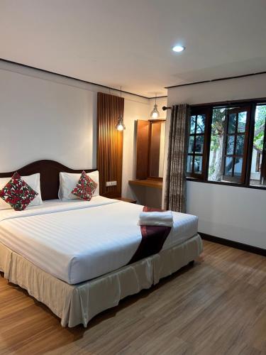 Ένα ή περισσότερα κρεβάτια σε δωμάτιο στο Clearwave resort Chumphon คลีนเวฟ รีสอร์ท