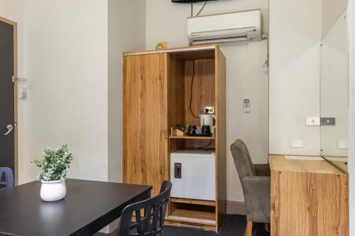 a room with a table and a small kitchen with a counter at Adelaide Paringa in Adelaide