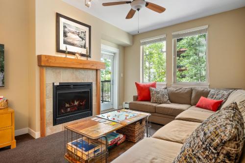 a living room with a couch and a fireplace at Fraser Crossing cabin in Winter Park