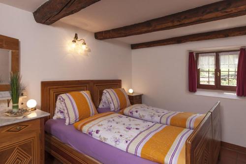 a bedroom with two beds and a vanity and a window at Antica Osteria Dazio in Fusio