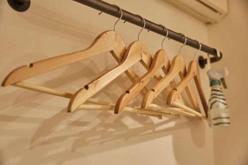 a group of wooden hangers hanging from a rack at Riverside Arashiyama in Kyoto