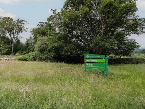 a green sign in the middle of a field at 79 Laurel Bank in Gatehouse of Fleet