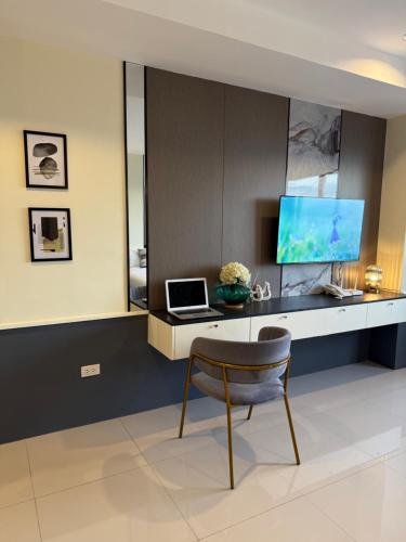 a room with a desk with a laptop and a chair at Sitari 23 Condo unit in Bacolod City in Bacolod