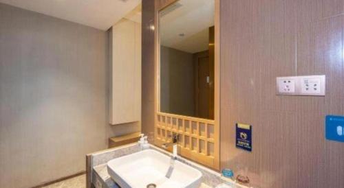 a bathroom with a sink and a mirror at East Queen Hotel (Xi'an Beimen Metro Station) in Xi'an