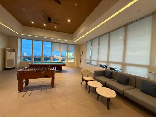 a living room with a couch and a pool table at Sitari 23 Condo unit in Bacolod City in Bacolod