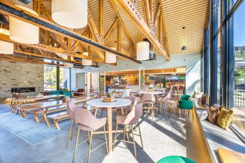 a restaurant with tables and chairs and windows at Nightcap at York on Lilydale in Mount Evelyn