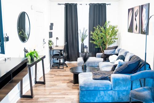 a living room with a blue couch and a table at The Cozy Grey Haven Home - 1st floor in Reading
