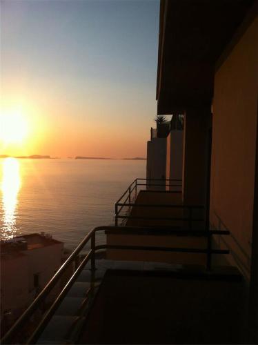 a sunset over the water from a house at Apartamentos Mar i Vent in San Antonio