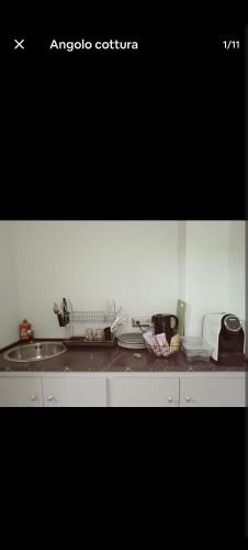 a kitchen counter top with a sink and a counter top at Room private Ossi in Ossi
